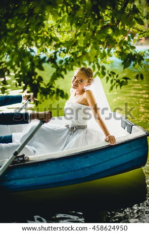 fragile bride posing in a boat for photographer