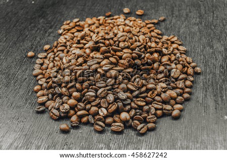 Roasted brown coffee beans, black wooden  background and texture, business card mock up background and texture,