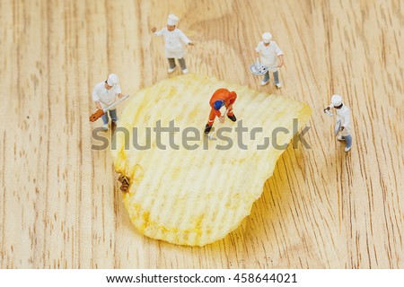 Potato chips on wooden background
