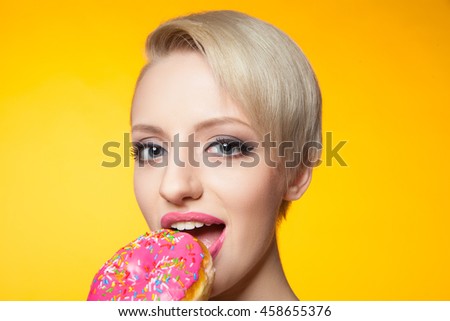 Blondie eating delicious pink donut