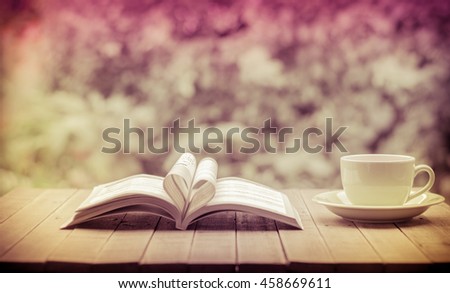 Pages of a book curved into a heart shape.heart of the book.coffee background,old book page decorate to heart shape for love in valentine day.