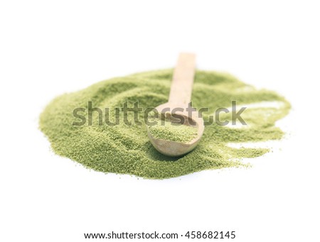 Matcha green tea powder in wooden spoon isolated on a white background.