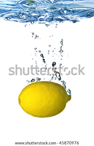 Fresh lemon dropped into water with bubbles isolated on white