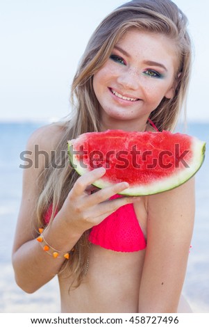 Pretty girl with slice of watermelon