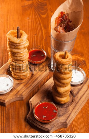 snacks to beer on a wooden table with sauce