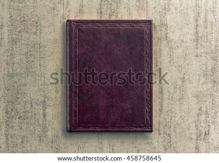 purple book on a grey grunge background, top view, retro toned image