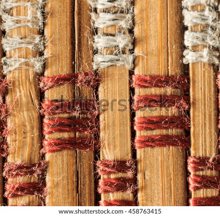 Texture of old bamboo branches with threads. Abstract background for design.