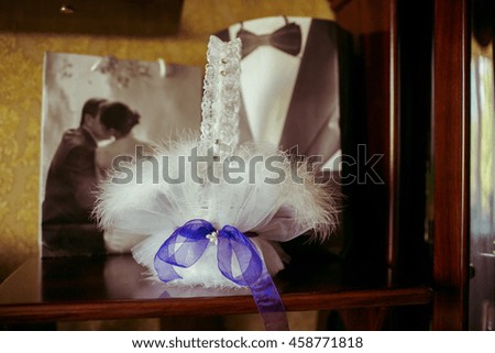 Wedding basket decorated with white feathers stands on the table