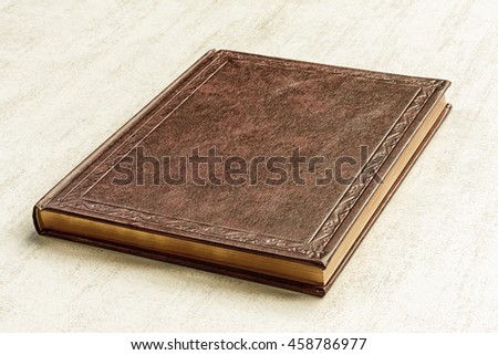 the book is brown on a gray background close up