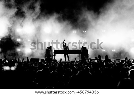 DJ Musician Band in Black and White Silhouette and Crowd at a Music Festival Concert - Backlit.  Royalty-Free Stock Photo #458794336