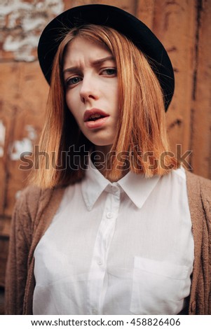 Young woman with hat. perplexity