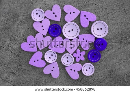 Buttons wooden heart shaped love on a gray background, buttons lot wood, lot of wooden buttons, purple buttons, background of buttons