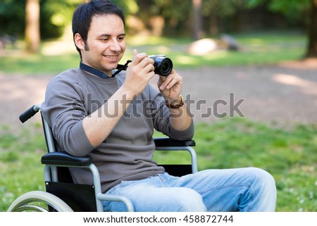 Smiling man using a mirrorless camera