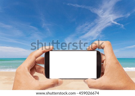 Hand male asian holding Smartphone taking picture of Landscape view Tropical beach