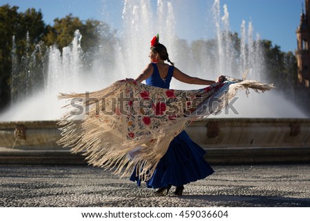 Beautiful woman dancing flamenco near the fountain Royalty-Free Stock Photo #459036604