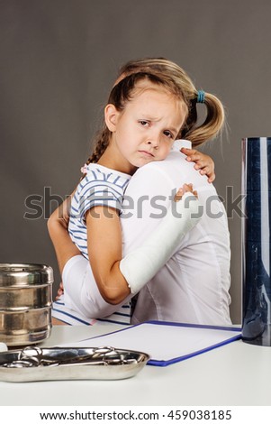 small young girl hugging woman doctor. medicine, health care and people concept
