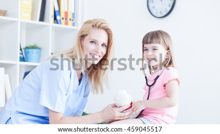 Cute little girl at doctor's office. Pediatrician with child