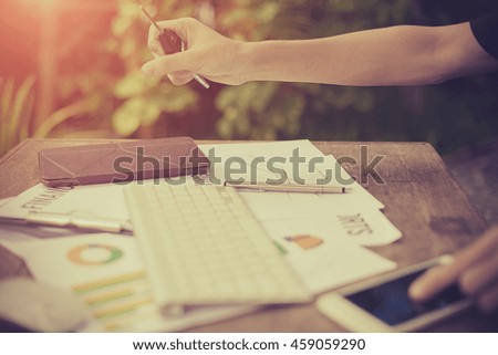 Business man holding "KEY" button stock chart and Keyboard
