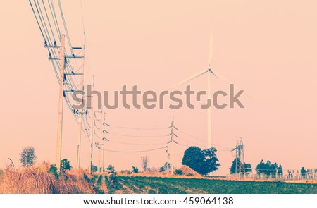 Wind turbines power generator on sky at farmer field - color filter effect style pictures