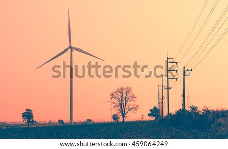 Wind turbines power generator on sky at farmer field - color filter effect style pictures