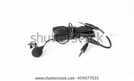 Black color small tie-clip on microphone lapel or lavalier. Isolated on white background. Slightly de-focused and close-up shot. Copy space.