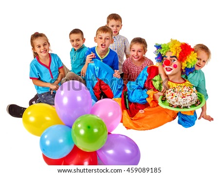 Clown keeps bunch of balloons and birthday cake with group children. Birthday celebration. Isolated.