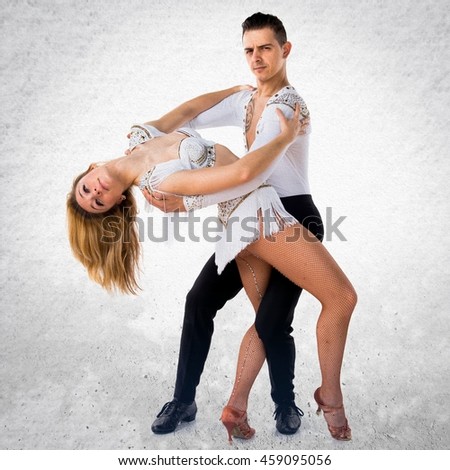 Two people dancing over textured background