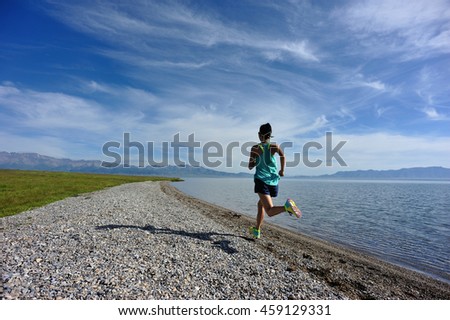 healthy young fitness woman runner running on seaside trail