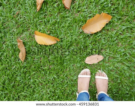 woman's feet on the grass floor 