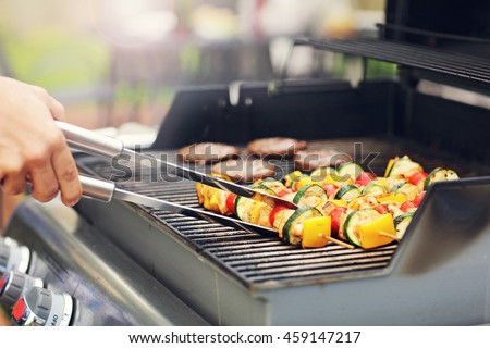 Closeup of grilled shashliks on grate Royalty-Free Stock Photo #459147217
