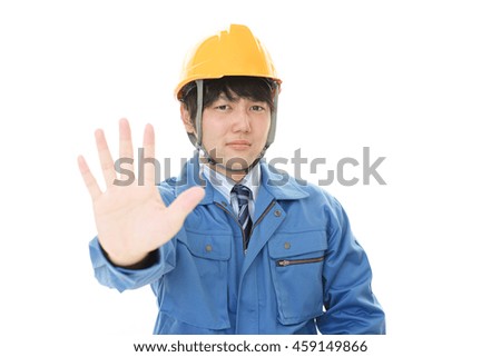 Asian worker making stop sign