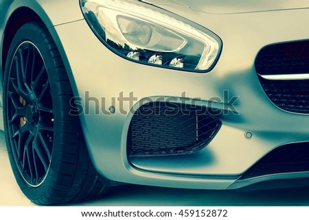 The Hood Of Modern German Sport Or Business Car With A Matte Silver Metallic  Coating, Black  Coolant Radiator Grille, Xenon  Head light, Bumper With  Park