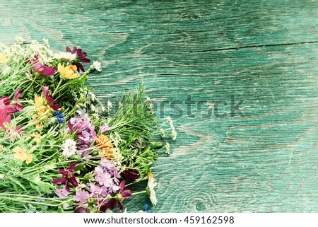 Bouquet of fresh summer flowers on the blue wooden grunge desk. Mock up for greeting cards, holiday postcards, invintation in vintage hipster eco rustic style with copy space
