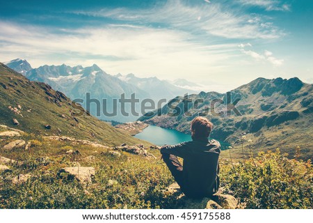 Traveler Man relaxing meditation with serene view mountains and lake landscape Travel Lifestyle hiking concept summer vacations outdoor  Royalty-Free Stock Photo #459175588