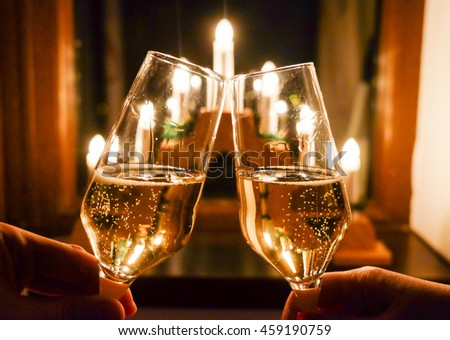 Glasses of Champagne with festive background and traditional decoration. Artistic interpretation.