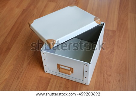 open white blank plastic storage box on wood floor