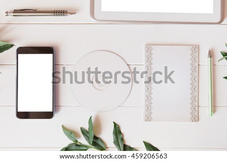 Styled natural eco home office. Smartphone, tablet, paper for notes, CD, DVD with copy space on white background. Product introducing  Top view, flat lay.