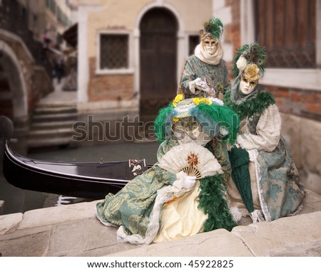 Three People  with  Carnival Costume to Venice Italy in background canale and gondola
