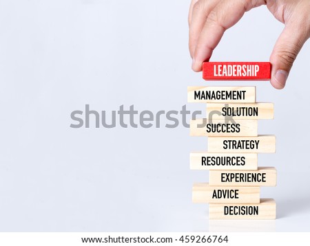 Businessman Building LEADERSHIP concept with Wooden Blocks Royalty-Free Stock Photo #459266764