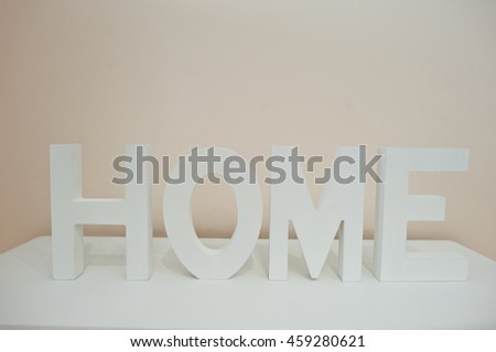 White wooden letters HOME on the shelf