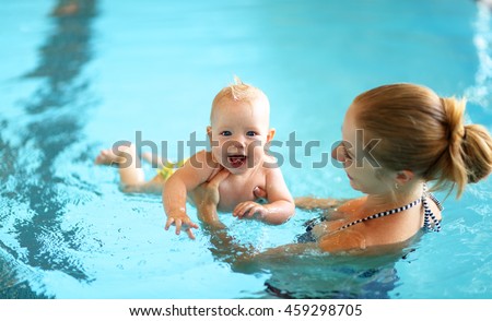 healthy family mother teaching baby swimming pool Royalty-Free Stock Photo #459298705