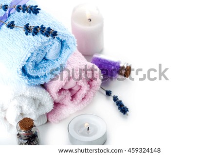 Lavender, essential oil, colorful stones and towel on a white background