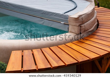 The ultimate garden accessory a free standing cedar wood and leather circular hot tub with cover.