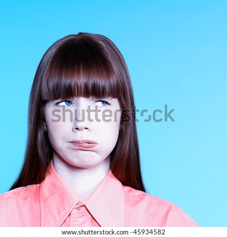 studio portrait of a young bored woman on isolated background