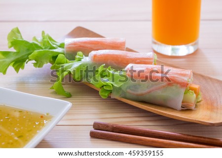 Salad roll crabvegetables and crab stick with salad seafood dressing in wooden plate