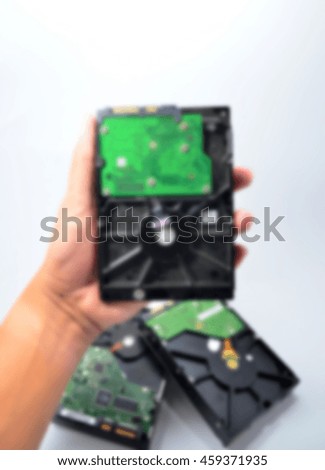 Blurred abstract background of hand hold hard disk