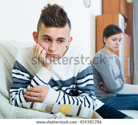 Upset mother and angry son arguing in domestic interior Royalty-Free Stock Photo #459385786