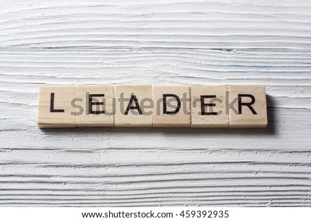 text of LEADER on wood abc cubes at wooden background