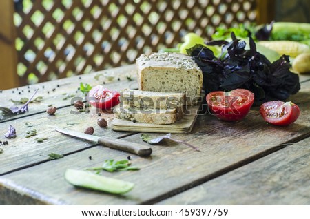 Fragrant rye bread with vegetables on a wooden table
