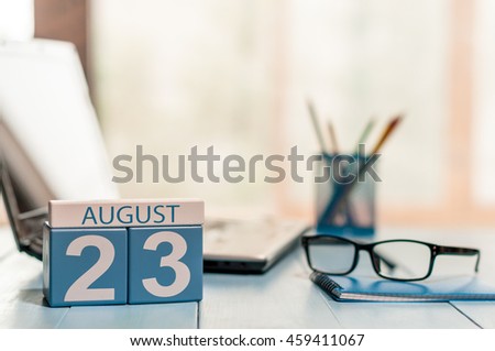 August 23rd. Day 23 of month, wooden color calendar on law office background. Summer time. Empty space for text